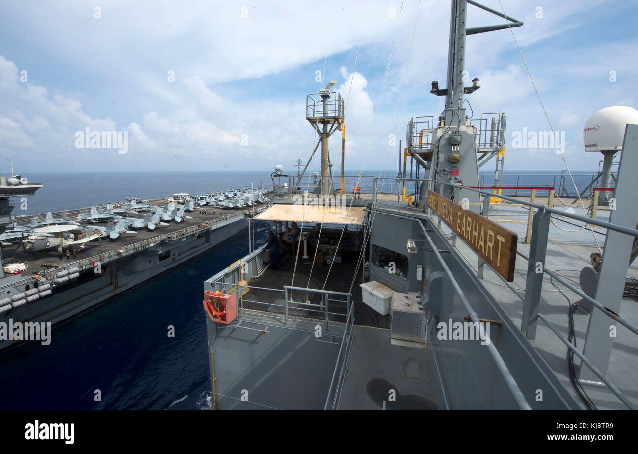 Military Sealift Command dry cargo and ammunition ship USNS Amelia Earhart (T-AKE 6) maneuvers alongside USS Theodore Roosevelt (CVN 76) during a repl Stock Photo