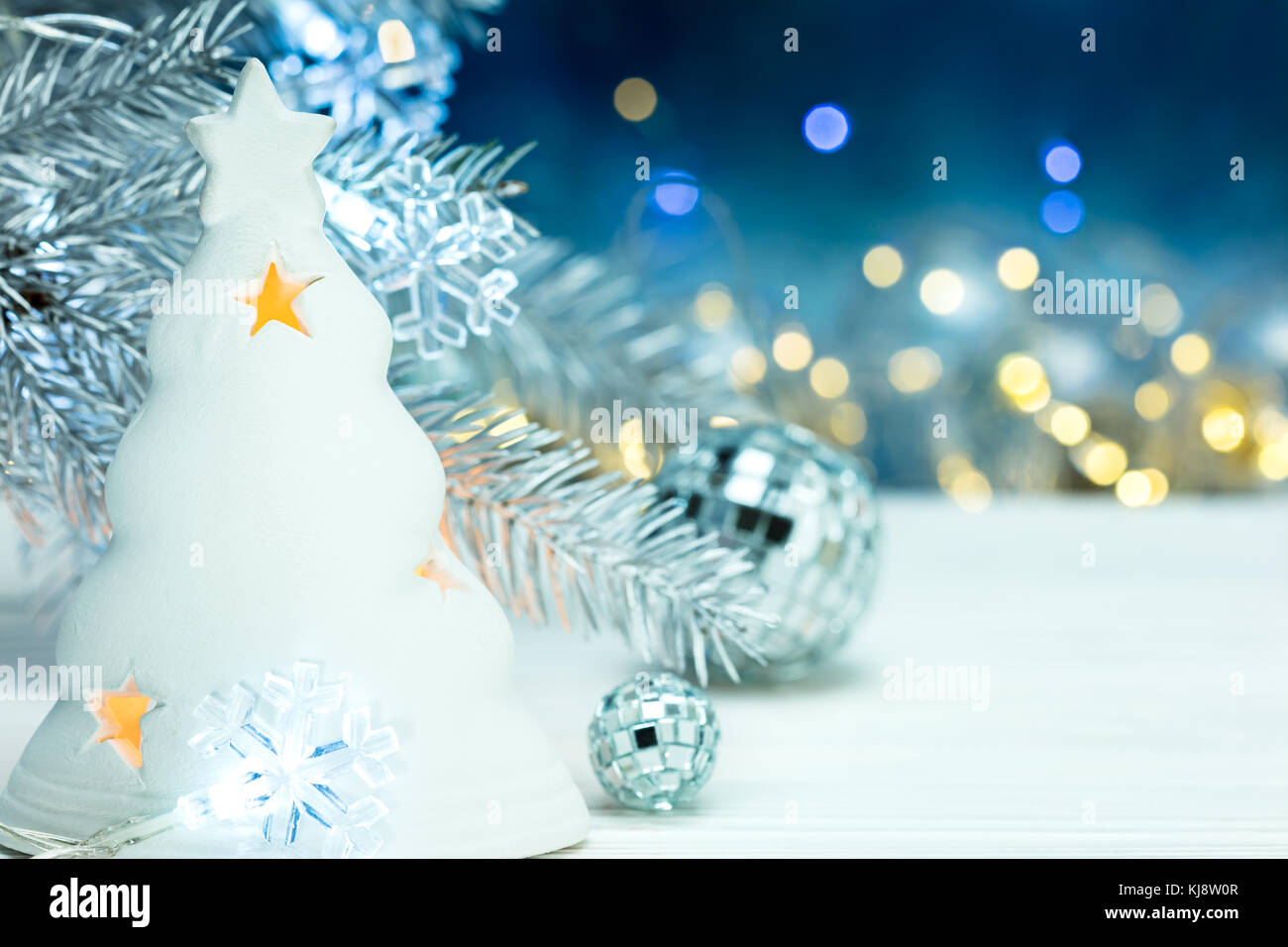 christmas tree decorations with fir tree branch on blurred lights ...
