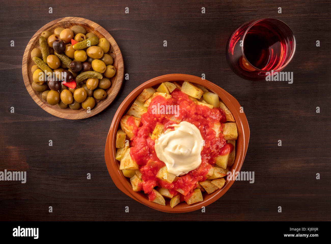 Overhead photo of traditional Spanish tapas. Pickled olives, patatas