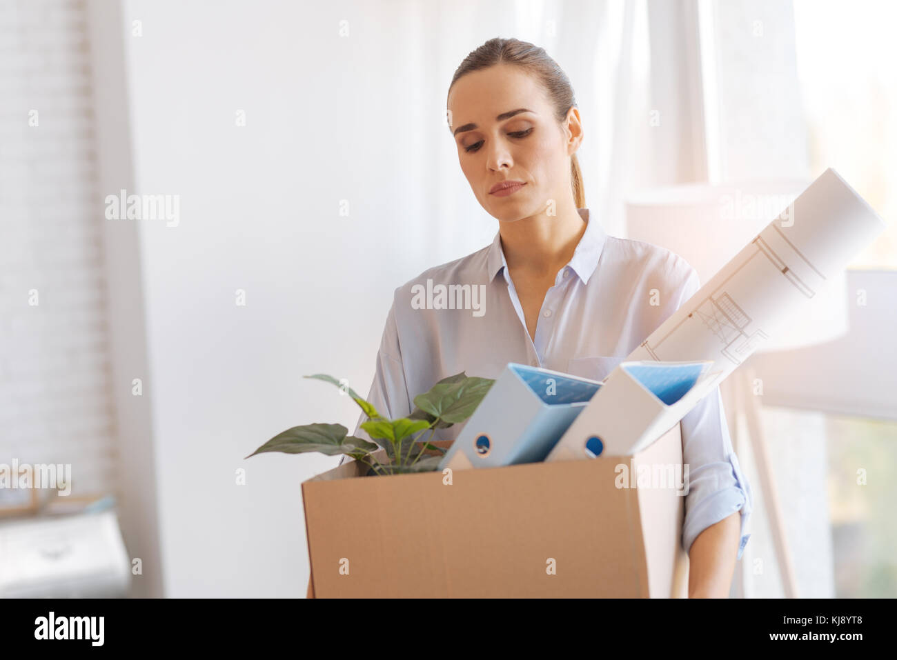 Calm tired woman coming home after being dismissed from work Stock Photo