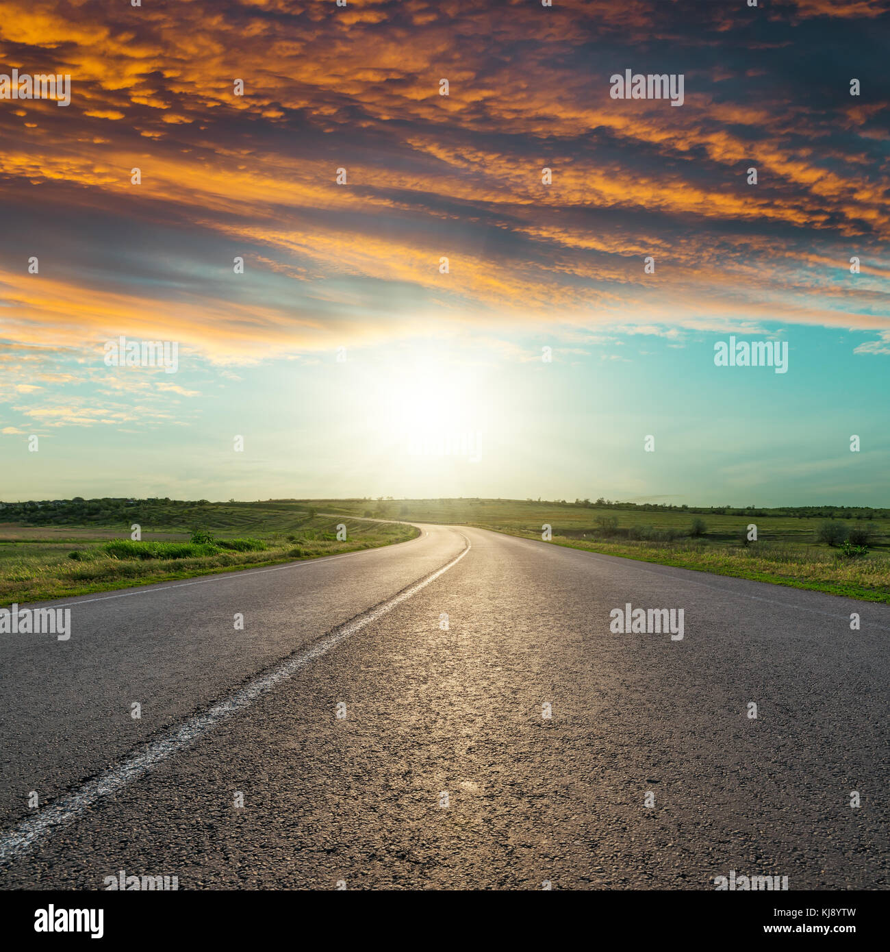 asphalt road to horizon in red clouds in sunset Stock Photo - Alamy