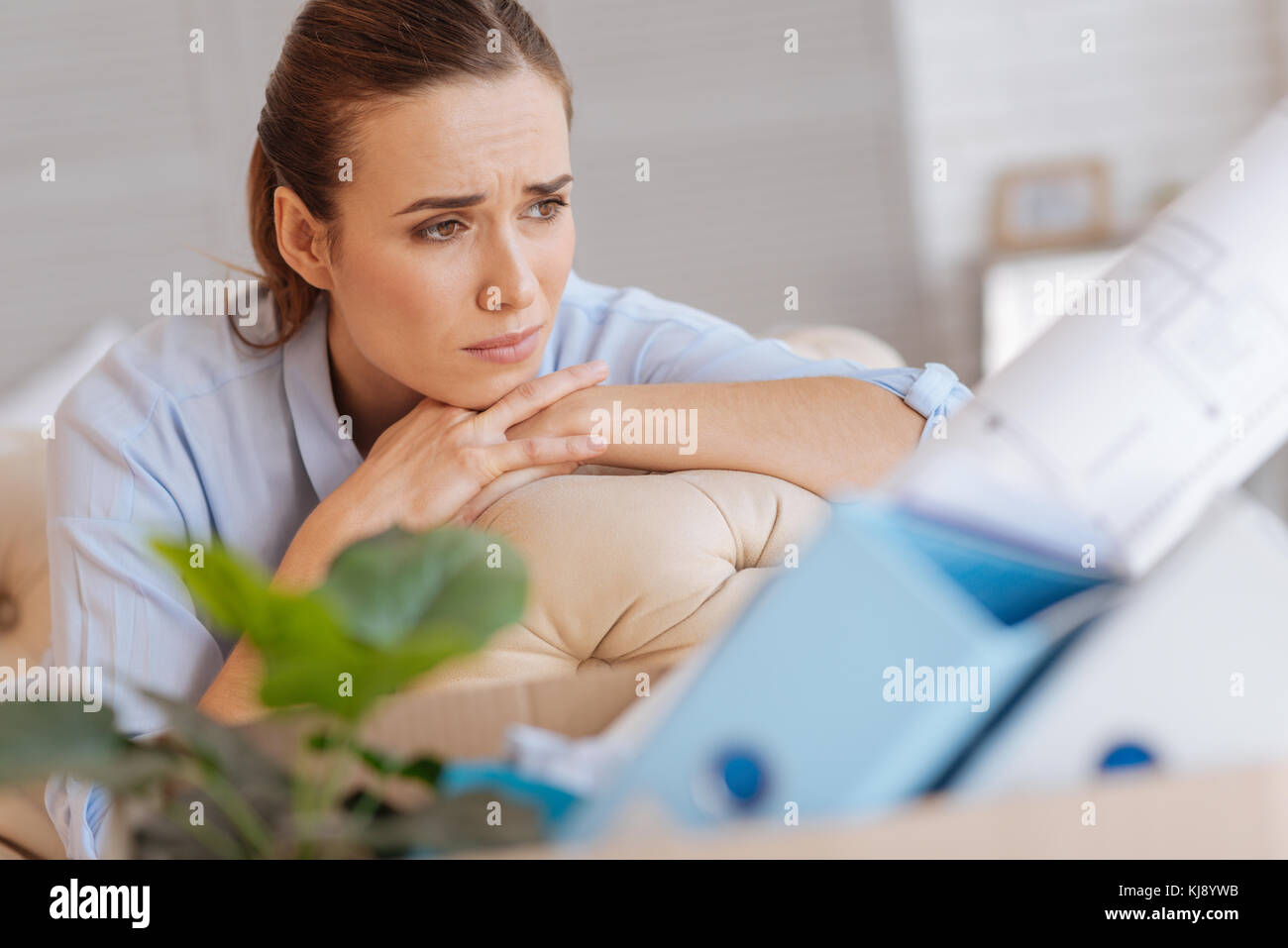 Beautiful portrait of a sad dismissed engineer sitting at home Stock Photo