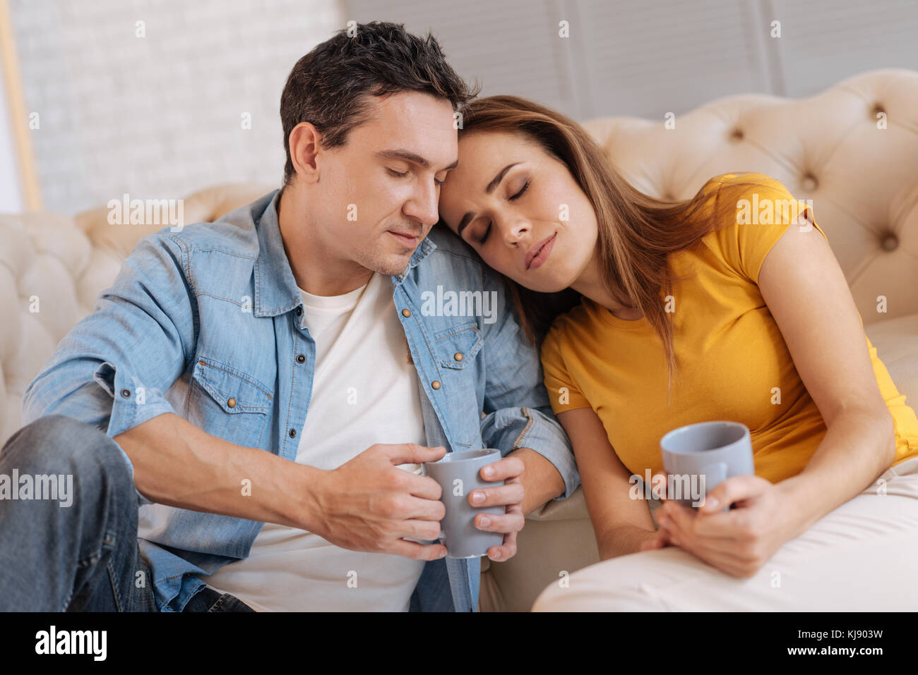Cute loving couple leaning their heads to each other Stock Photo