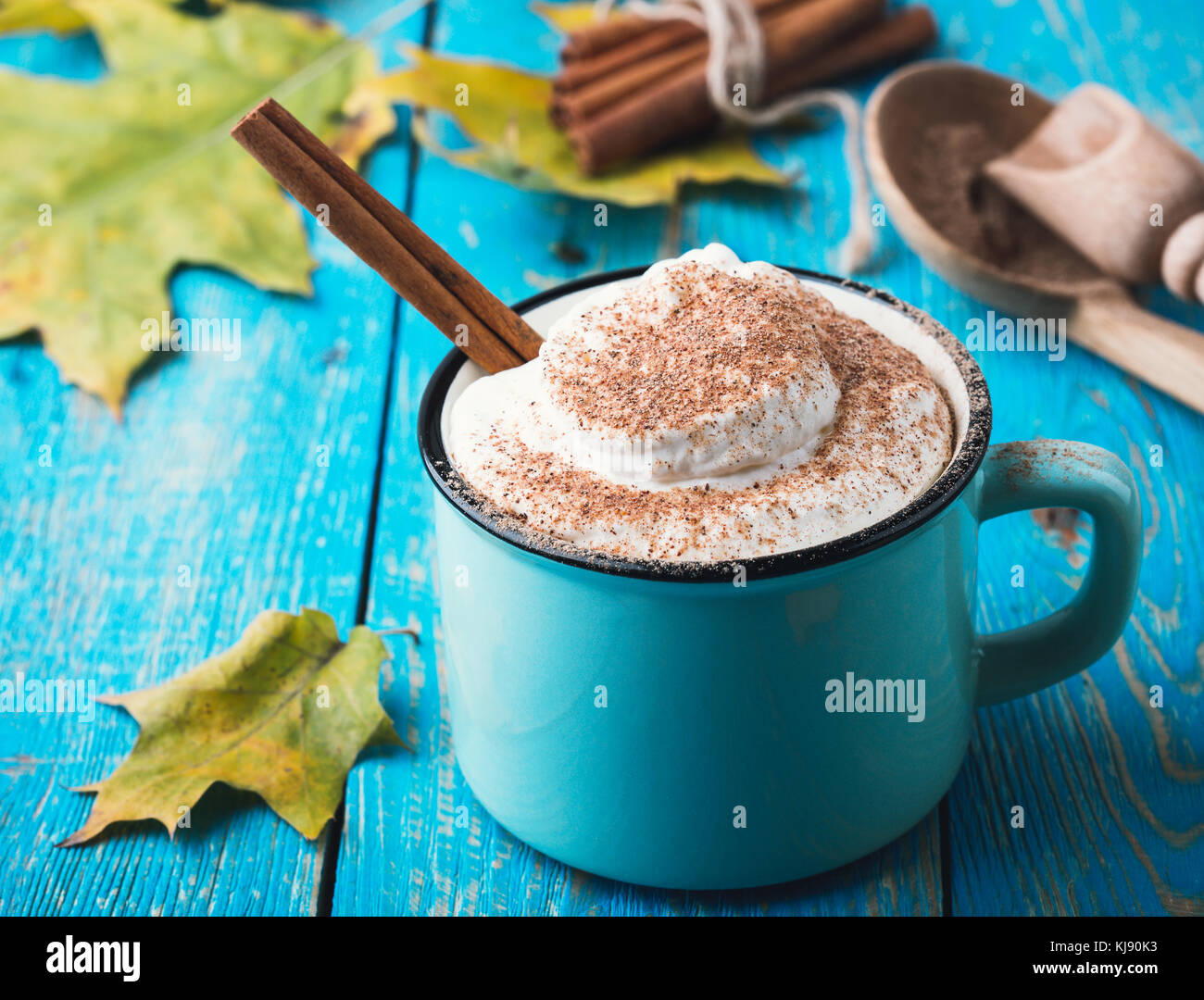 Pumpkin spice latte with whipped cream and cinnamon in rustic mug on ...