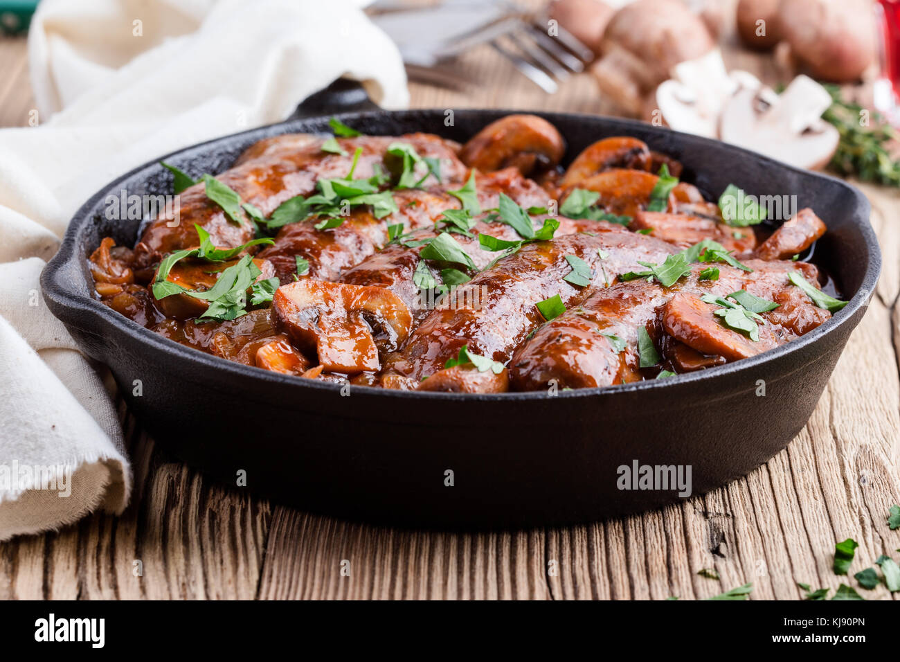 Sausages with onion and mushrooms gravy in cooking pan Stock Photo Alamy