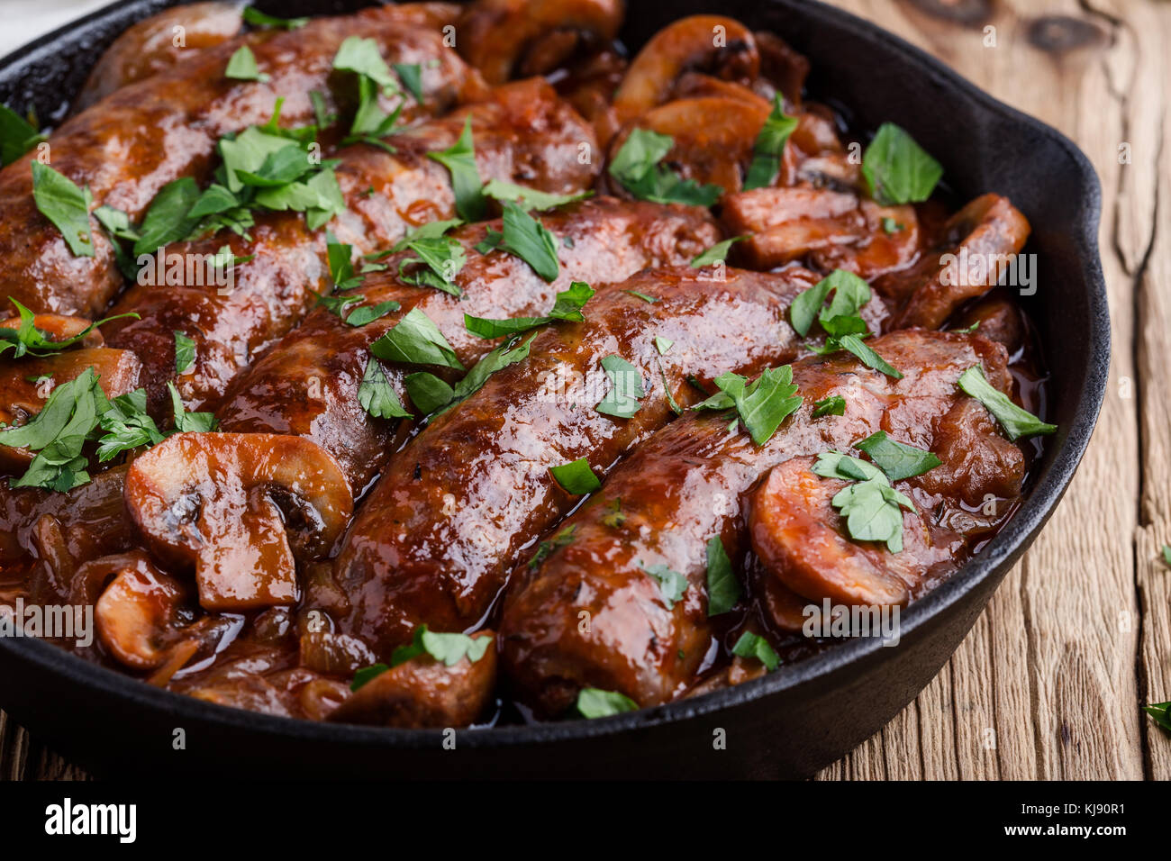 Sausages with onion and mushrooms gravy in cooking pan Stock Photo Alamy