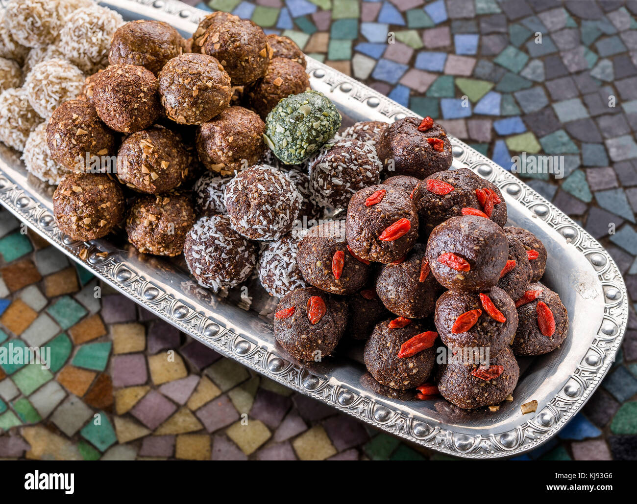 Raw food balls on a silver plate Stock Photo