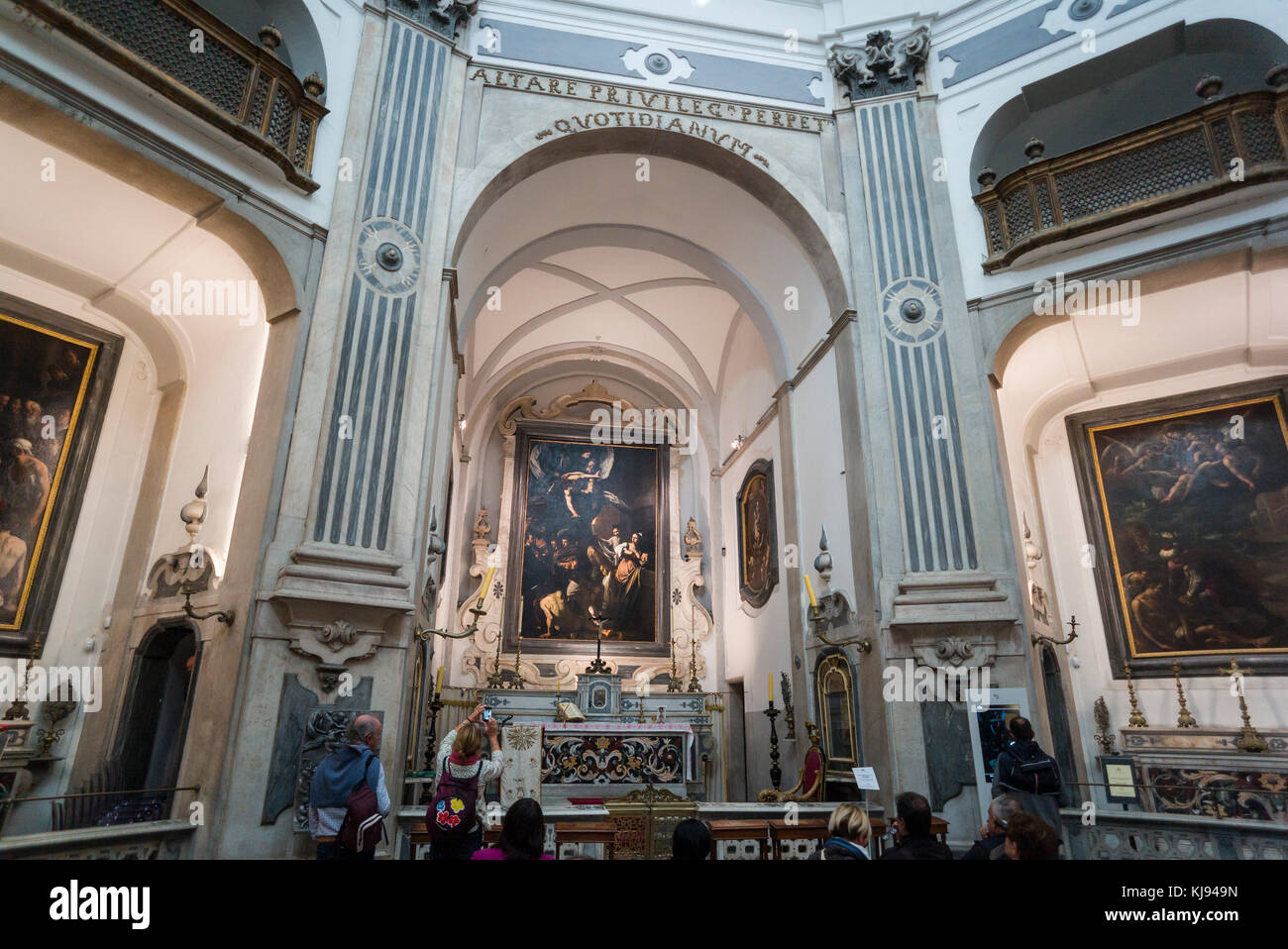 Naples. Italy. Interior of the church of Pio Monte della Misericordia, and Caravaggio's The Seven Works of Mercy above the altar. Stock Photo