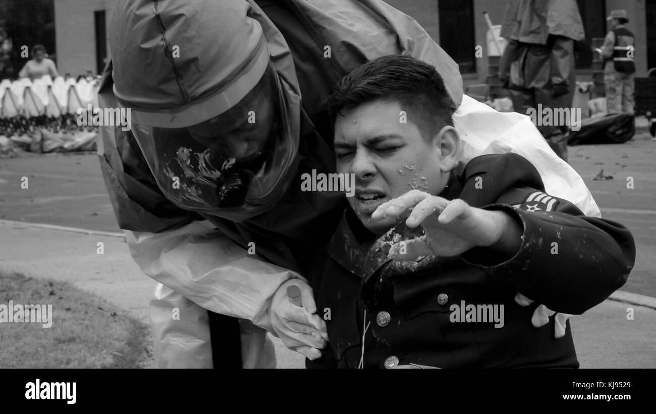 A 2nd Medical Group decontamination team member assesses a simulated chemical attack victim during a chemical, biological, radiological and nuclear attack decontamination exercise on Barksdale Air Force Base, La., Nov. 15, 2017. The exercise tested the 2nd MDG’s response to victims of a chemical, biological, radiological or nuclear attack. (U.S. Air Force photo by Staff Sgt. Benjamin Raughton) Stock Photo