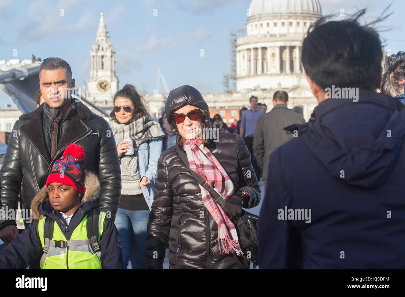 London, UK. 23rd Nov, 2017. People struggle with the blustery cold weather conditions walking on Millenium Bridge London with winds likely to gust up to 60mph in some places  Credit: amer ghazzal/Alamy Live News Stock Photo