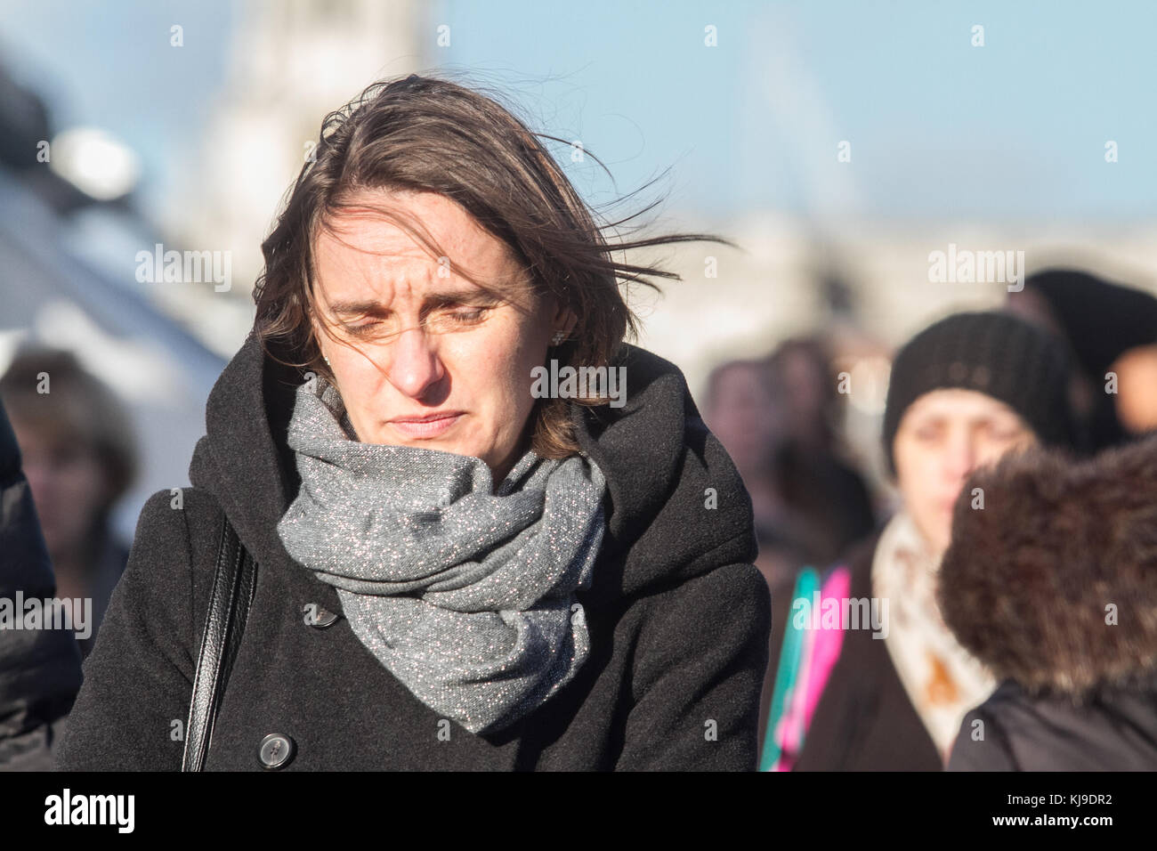 London, UK. 23rd Nov, 2017. People struggle with the blustery cold weather conditions walking on Millenium Bridge London with winds likely to gust up to 60mph in some places  Credit: amer ghazzal/Alamy Live News Stock Photo