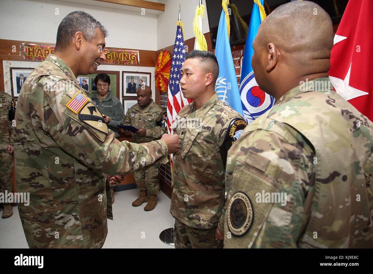 Paju, South Korea. 23rd November, 2017. U.S. Army Gen. Vincent Brooks, U.S. and U.N. Forces Korea commander, left, presents the Army Commendation medal to U.S. and South Korean soldiers during a Thanksgiving Day ceremony at Camp Bonifas on the Demilitarized Zone November 23, 2017 in Paju, South Korea. The soldiers were recognition for their efforts in rescuing a North Korean defector on November 13th. Credit: Planetpix/Alamy Live News Stock Photo