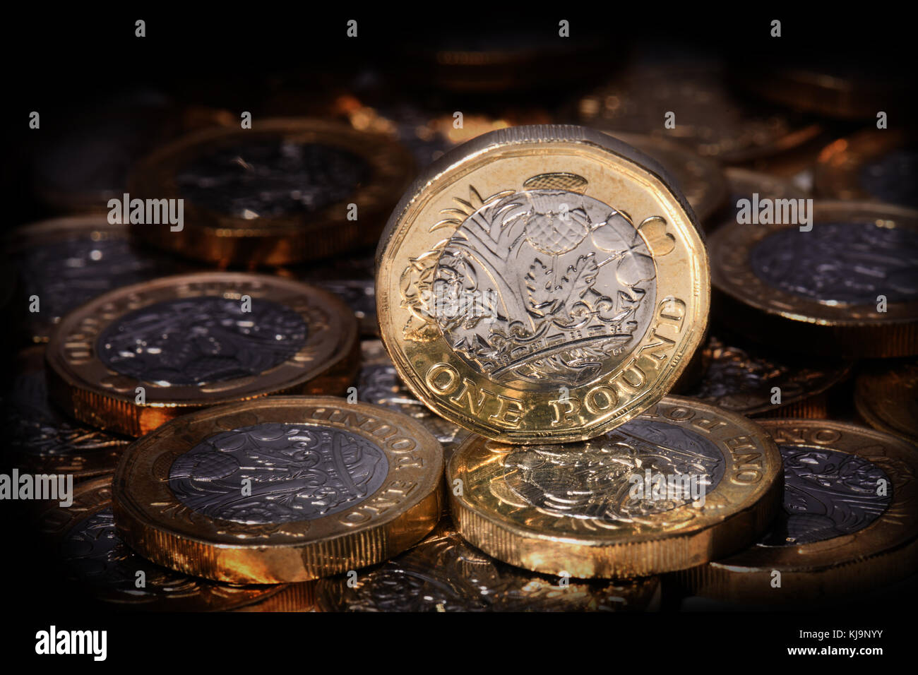 New one pound coin in a spotlight Stock Photo