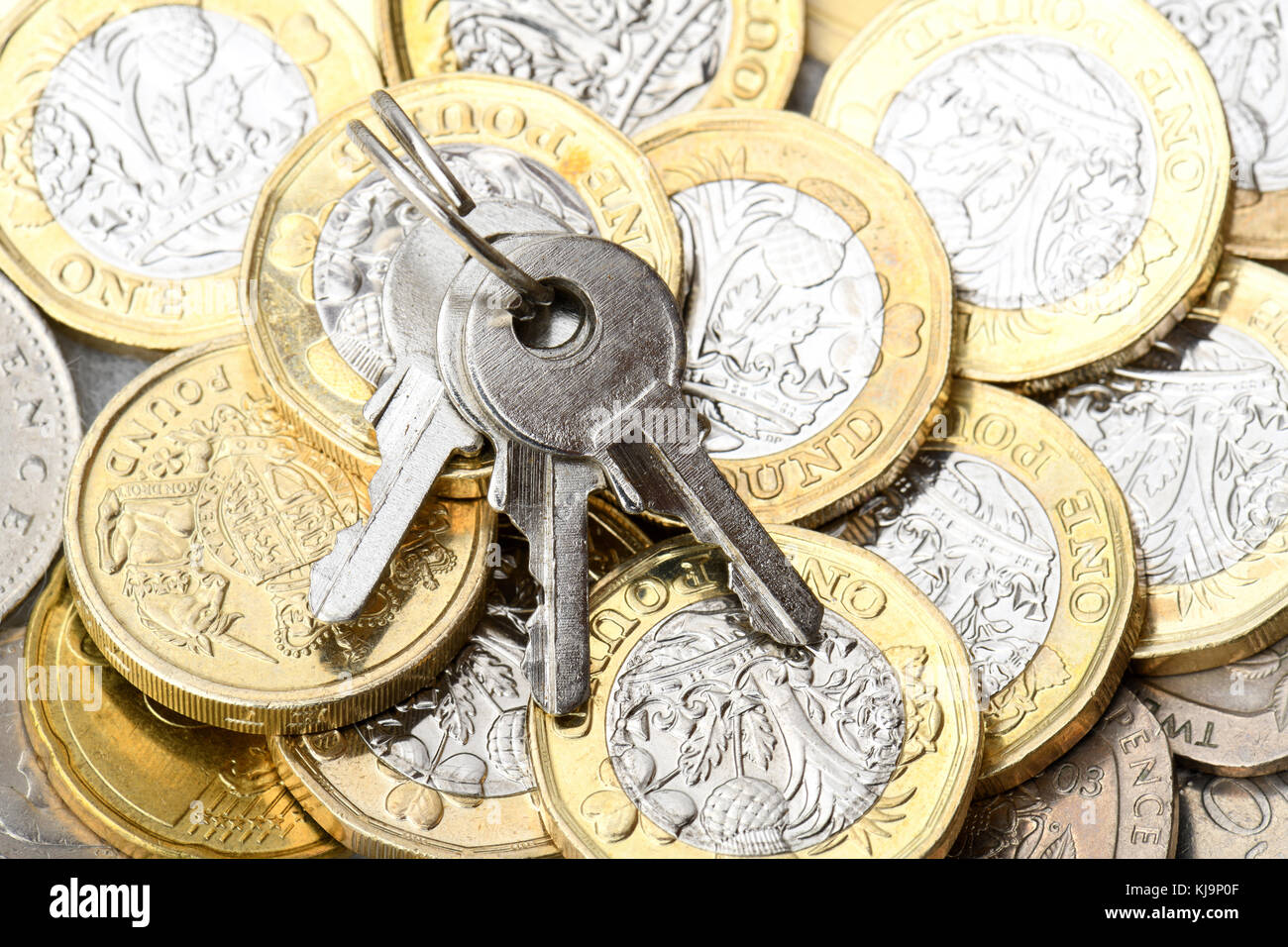 set of three keys on a background on gold coins Stock Photo