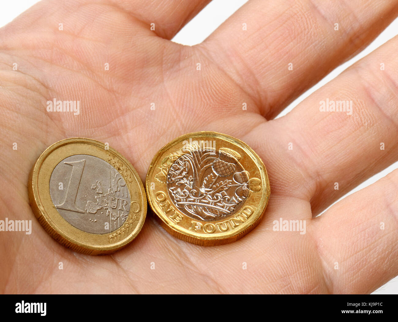 euro and pound coins in palm of hand Stock Photo