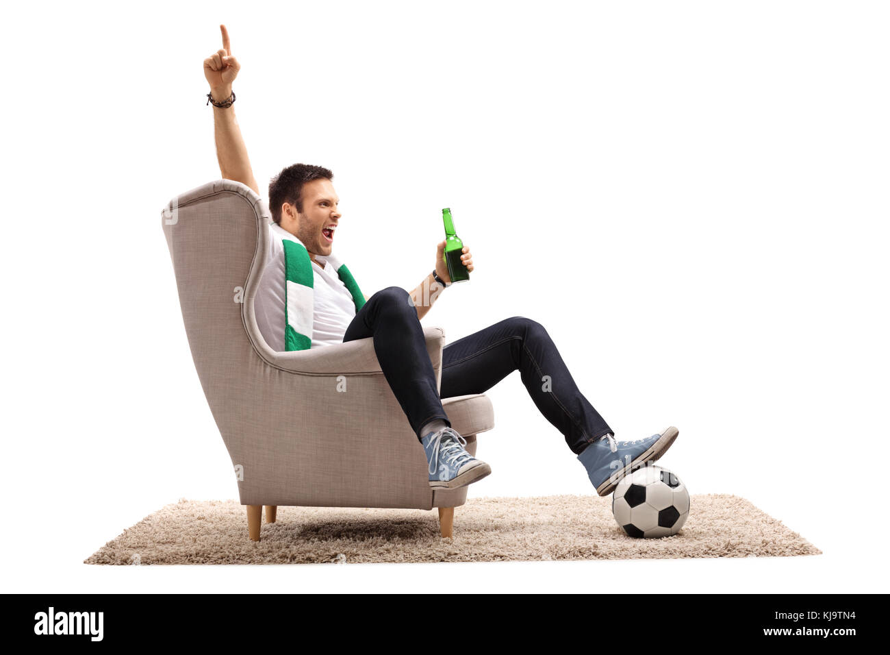 Excited football fan with a scarf and a beer bottle seated in an