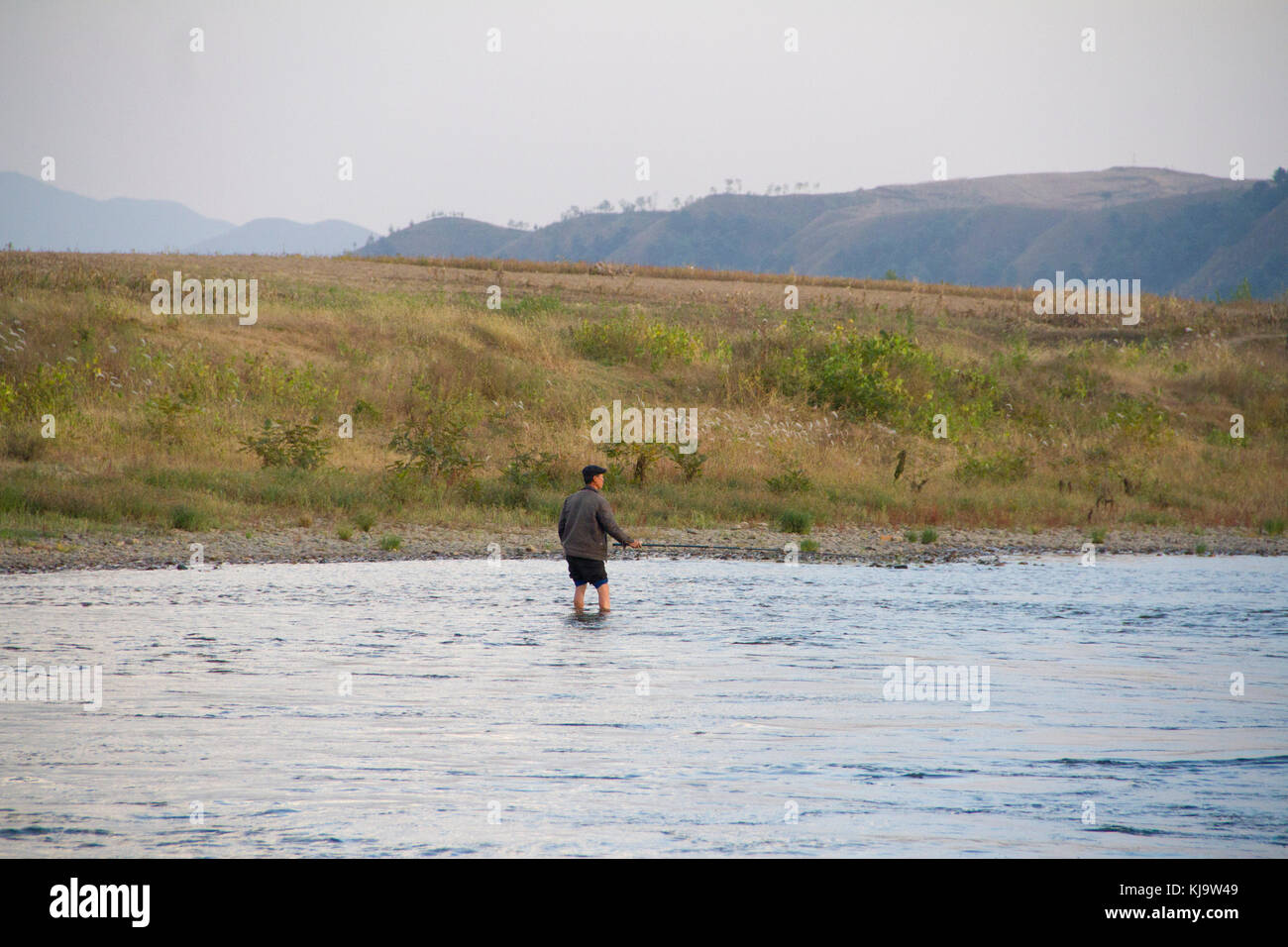 Yalu Fish A North Korean man fishes in the Yalu river near the Chinese border ...