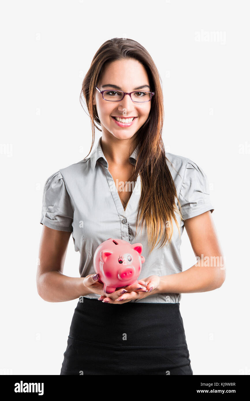 Beautiful and attractive young business woman smiling holding a piggy ...