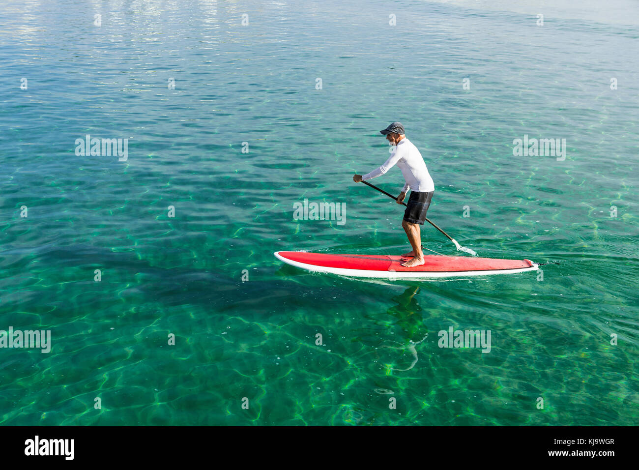 A senior man practicing paddle on a beautiful sunny day Stock Photo
