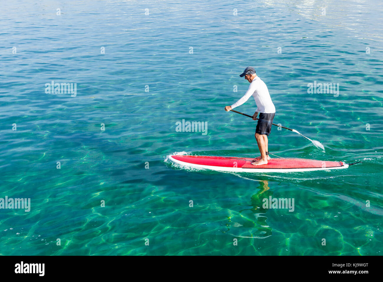 A senior man practicing paddle on a beautiful sunny day Stock Photo