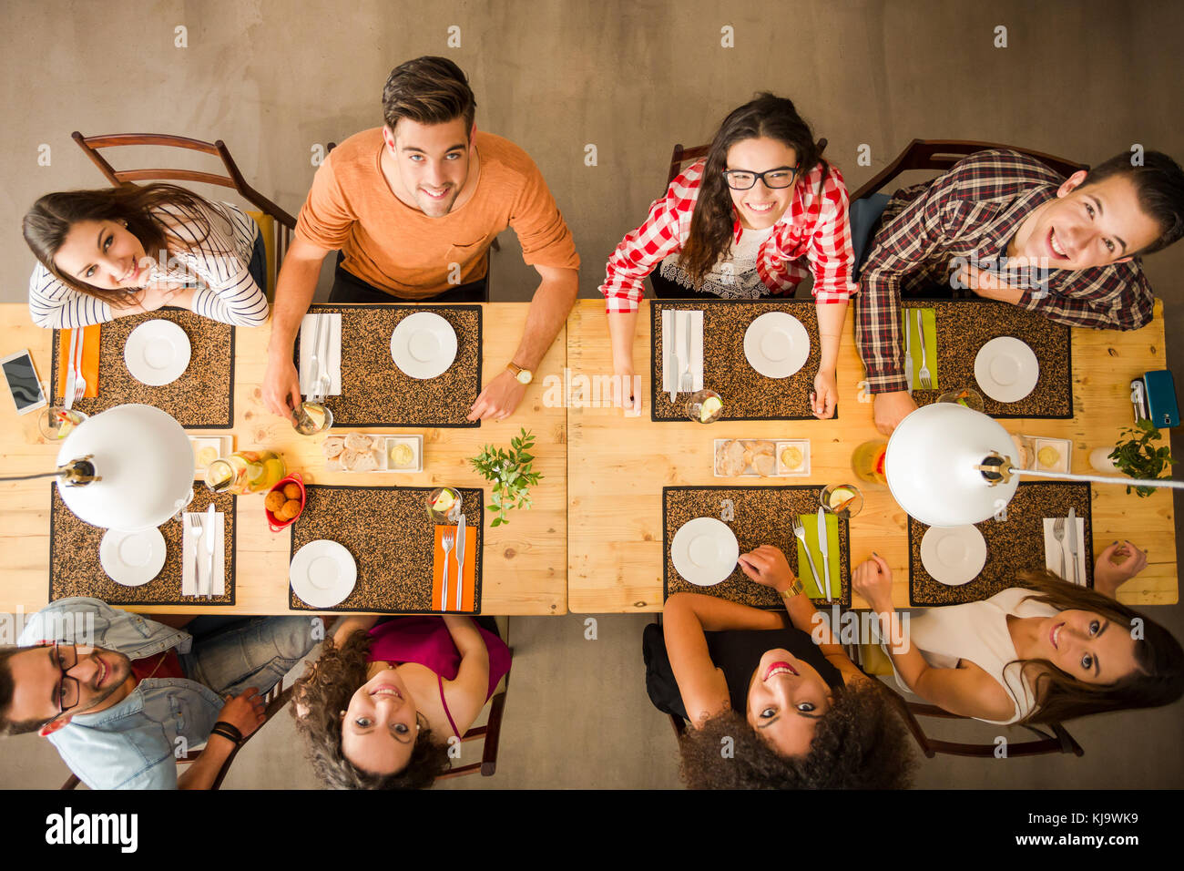 Group of people toasting and looking happy at a restaurant Stock Photo