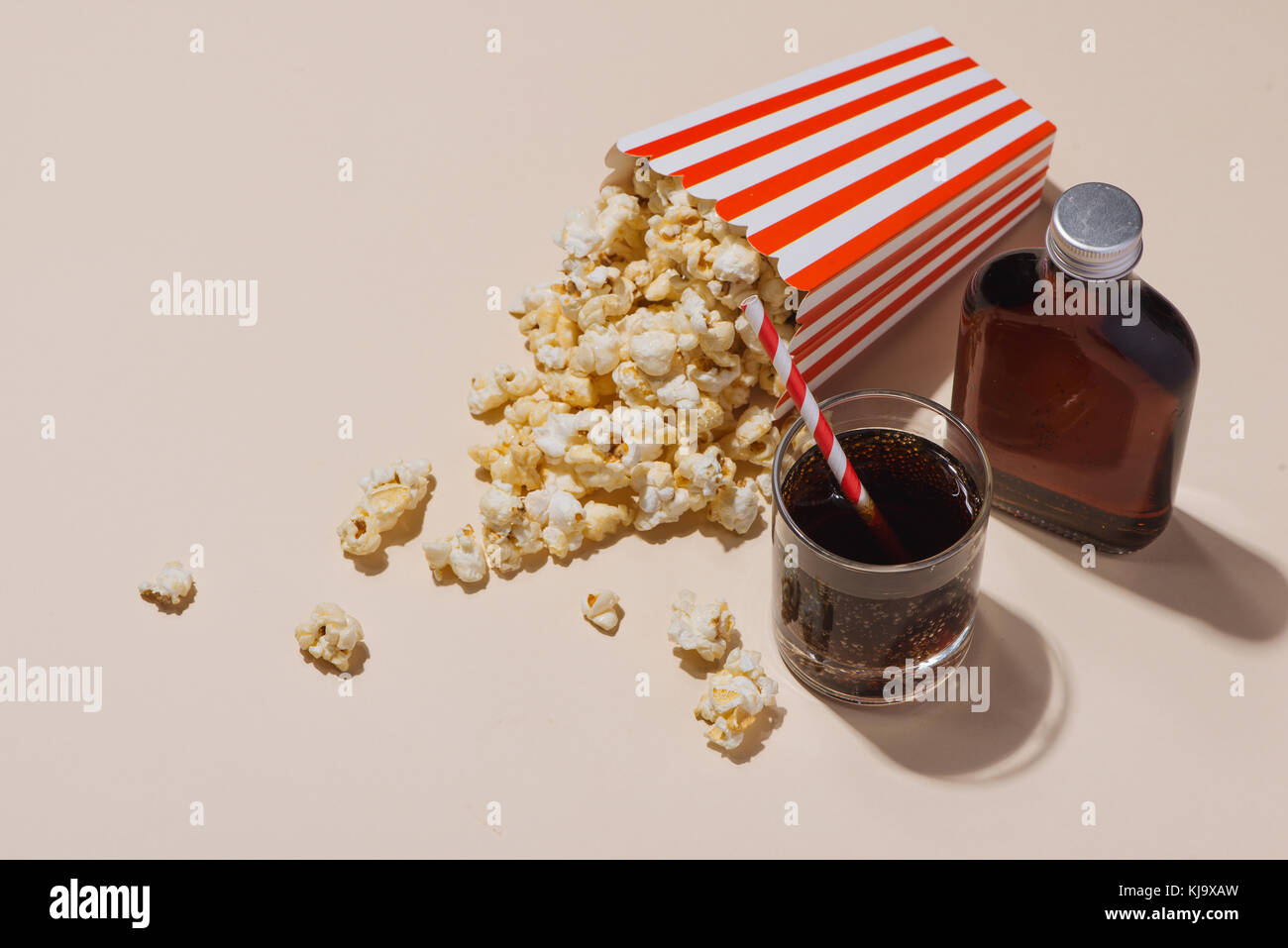 Popcorn in red and white cardboard with glass of soda Stock Photo