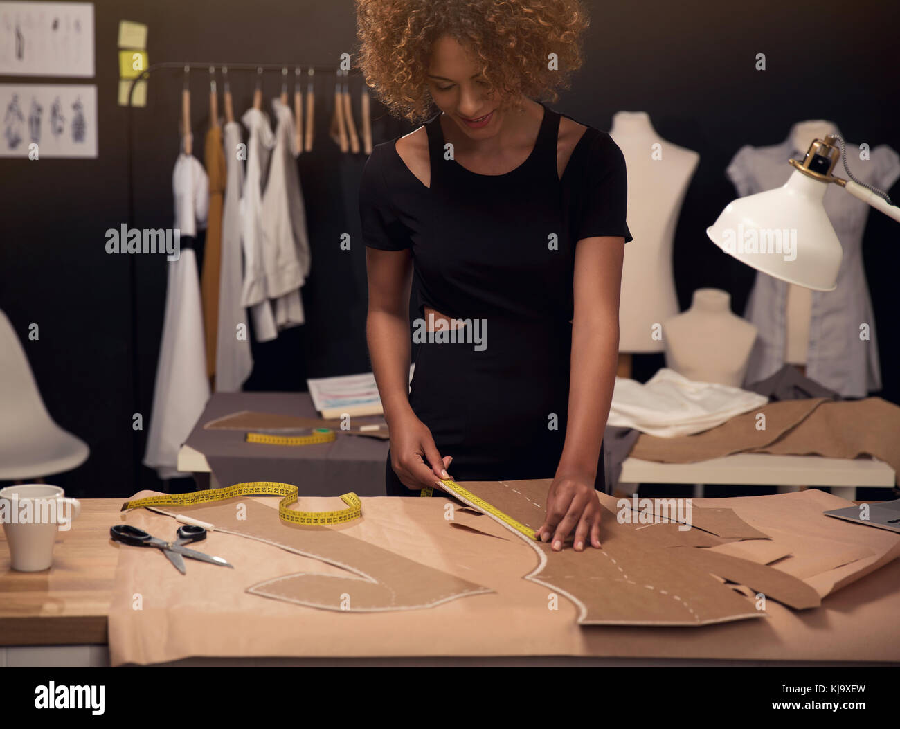 A young fashion designer working on her atelier Stock Photo - Alamy