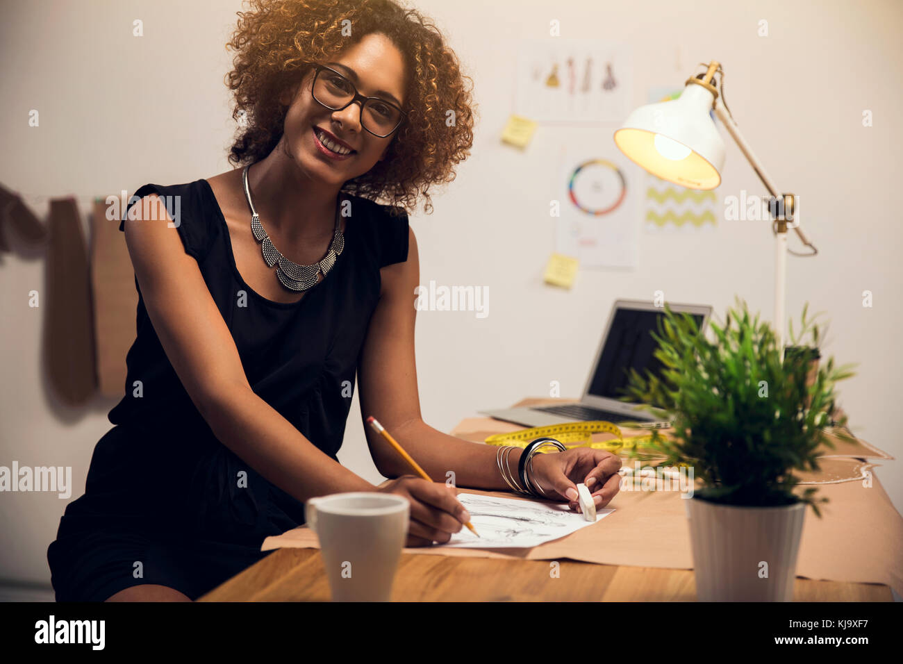 A young fashion designer working on her atelier Stock Photo - Alamy