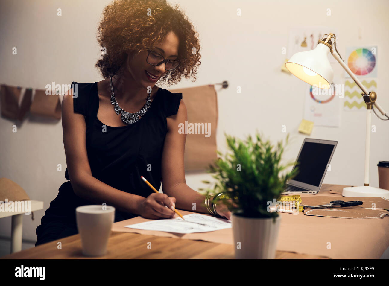A young fashion designer working on her atelier Stock Photo - Alamy