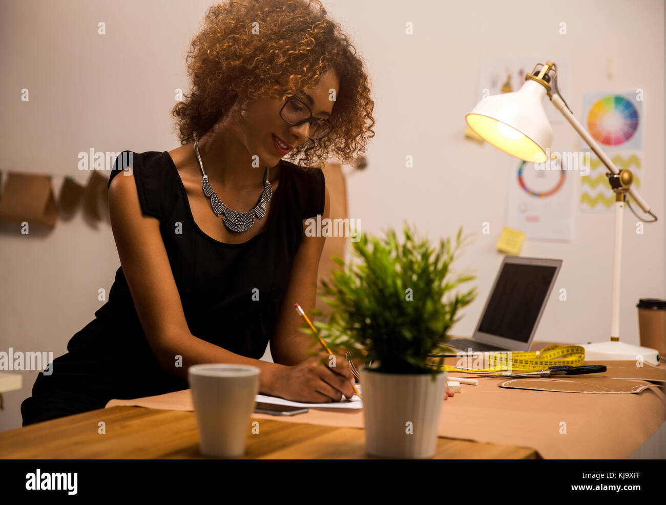 Portrait of a young fashion designer working on her atelier Stock Photo ...