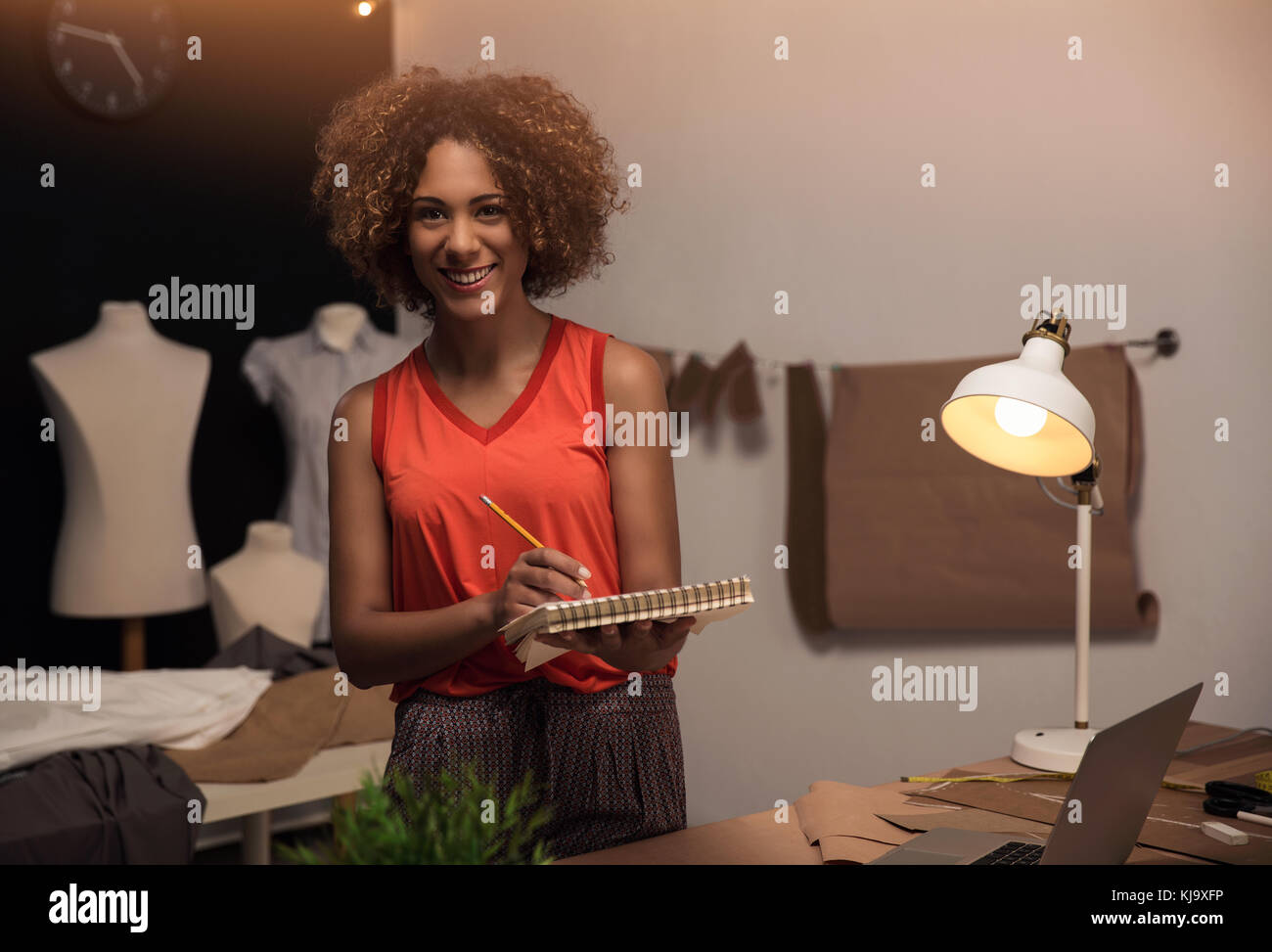 A young fashion designer working on her atelier Stock Photo - Alamy