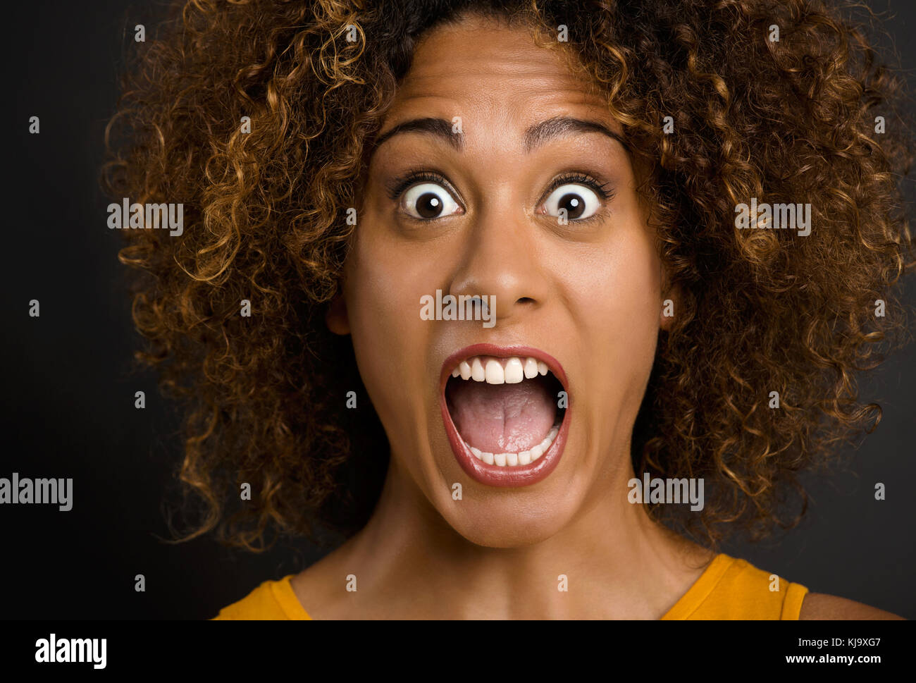 Portrait of a beautiful African American woman shoched with the news Stock Photo