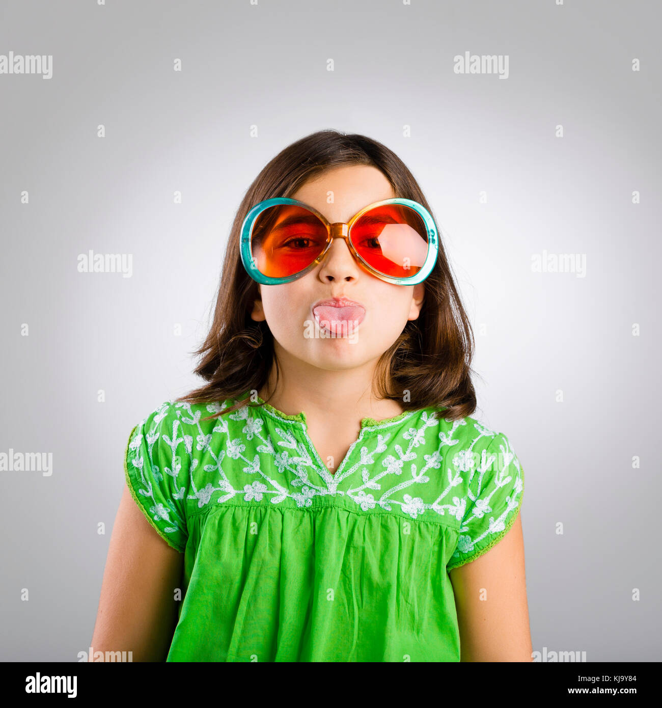 Portrait of a happy young girl wearing funny sunglasses Stock Photo