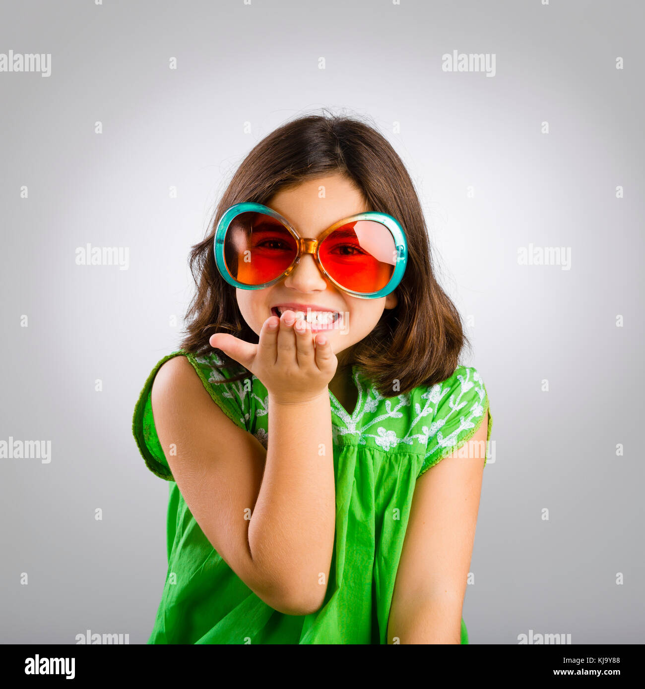 Portrait of a happy young girl wearing funny sunglasses Stock Photo - Alamy