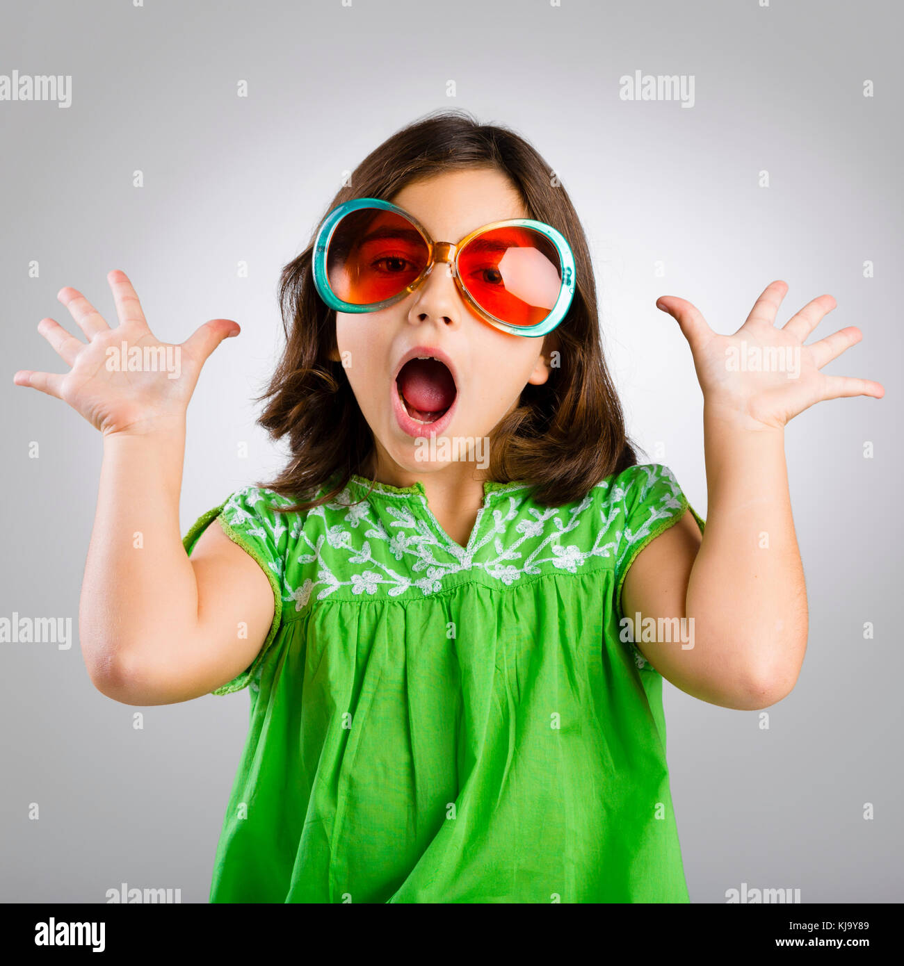 Portrait of a happy young girl wearing funny sunglasses Stock Photo Alamy
