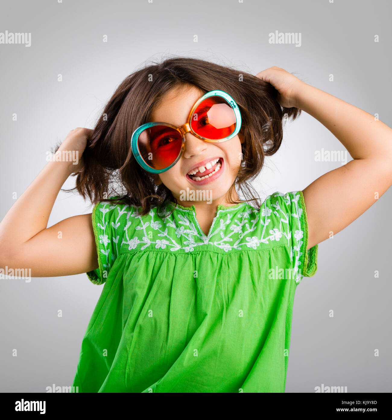 Portrait of a happy young girl wearing funny sunglasses Stock Photo - Alamy