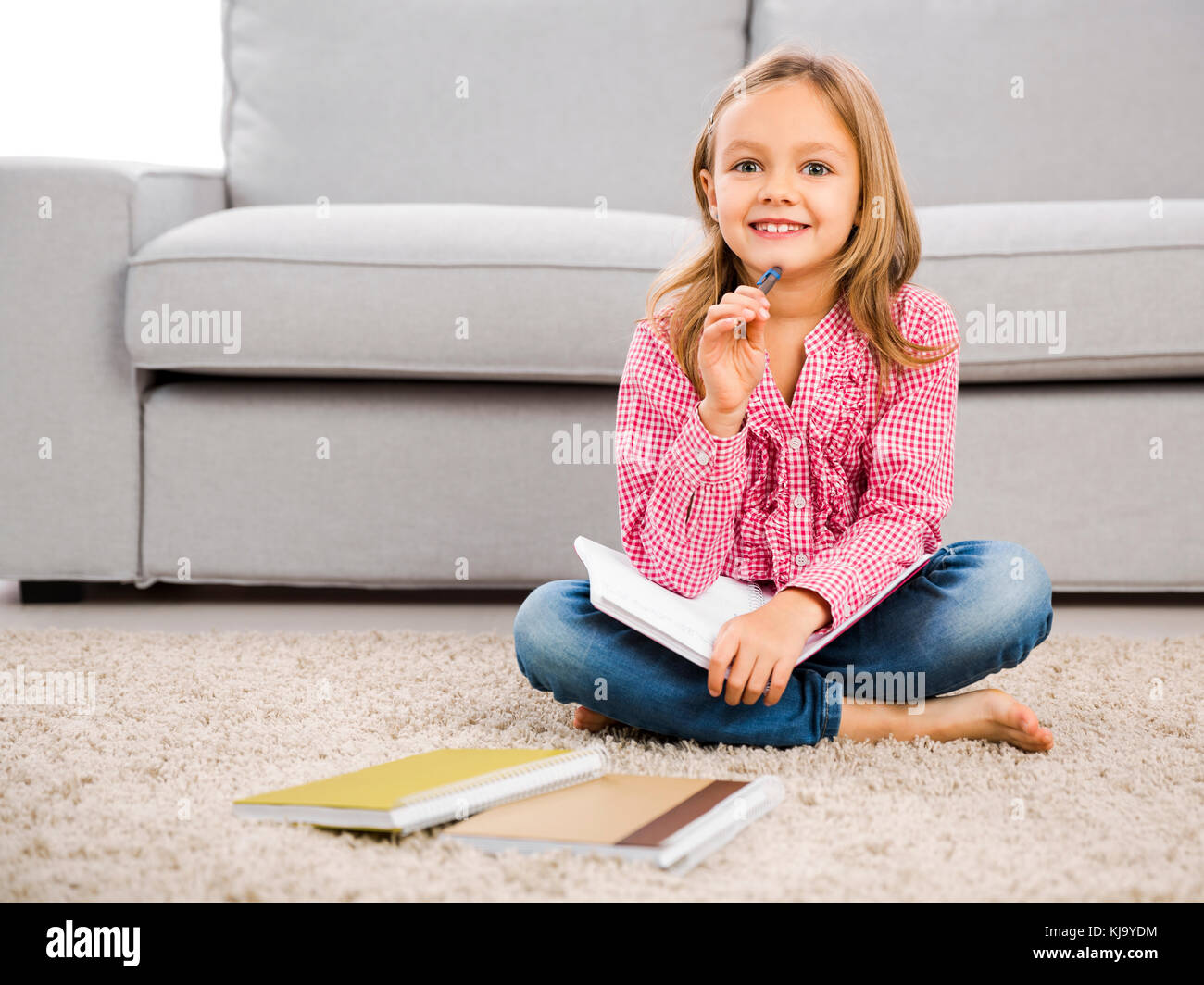 Cute little girl at home studying Stock Photo - Alamy