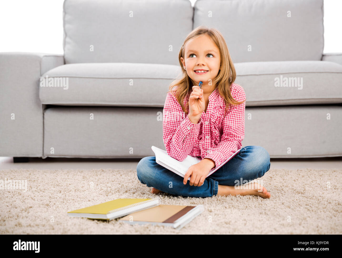 Cute little girl at home studying Stock Photo Alamy