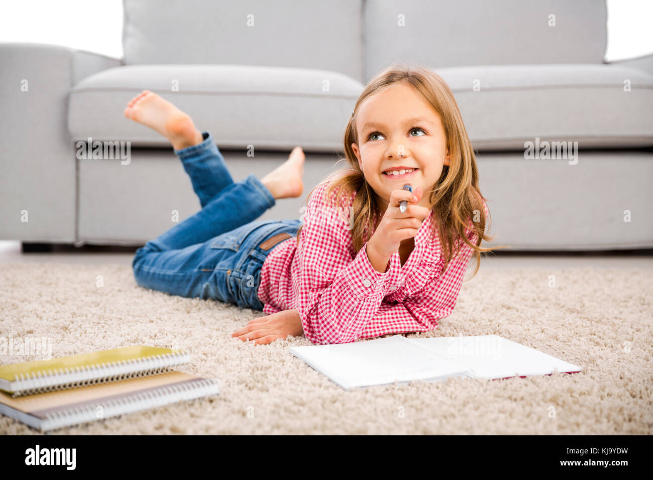 Cute little girl at home studying Stock Photo - Alamy