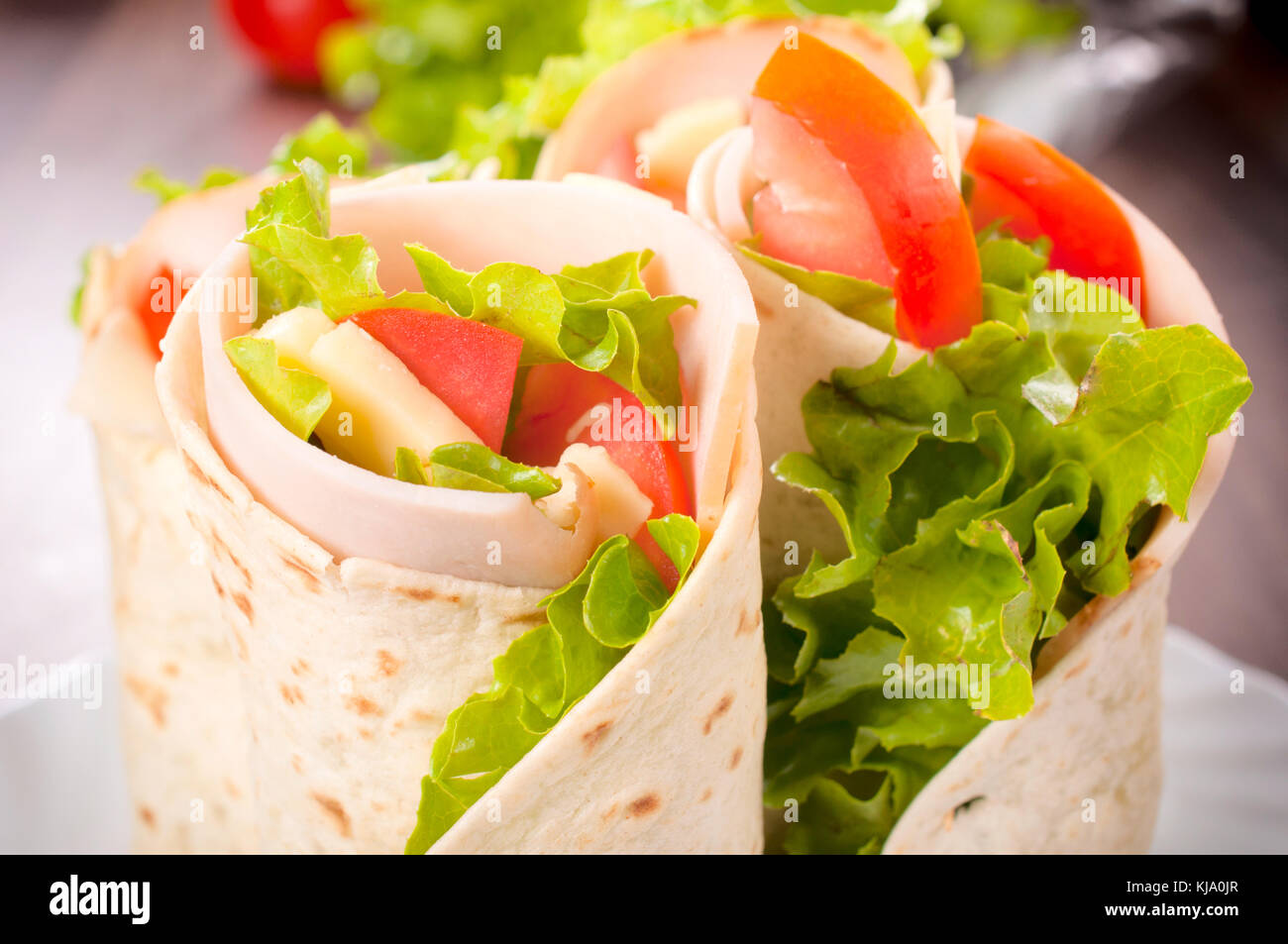 Tasty tortilla sandwich wrap with turkey and vegetables Stock Photo Alamy