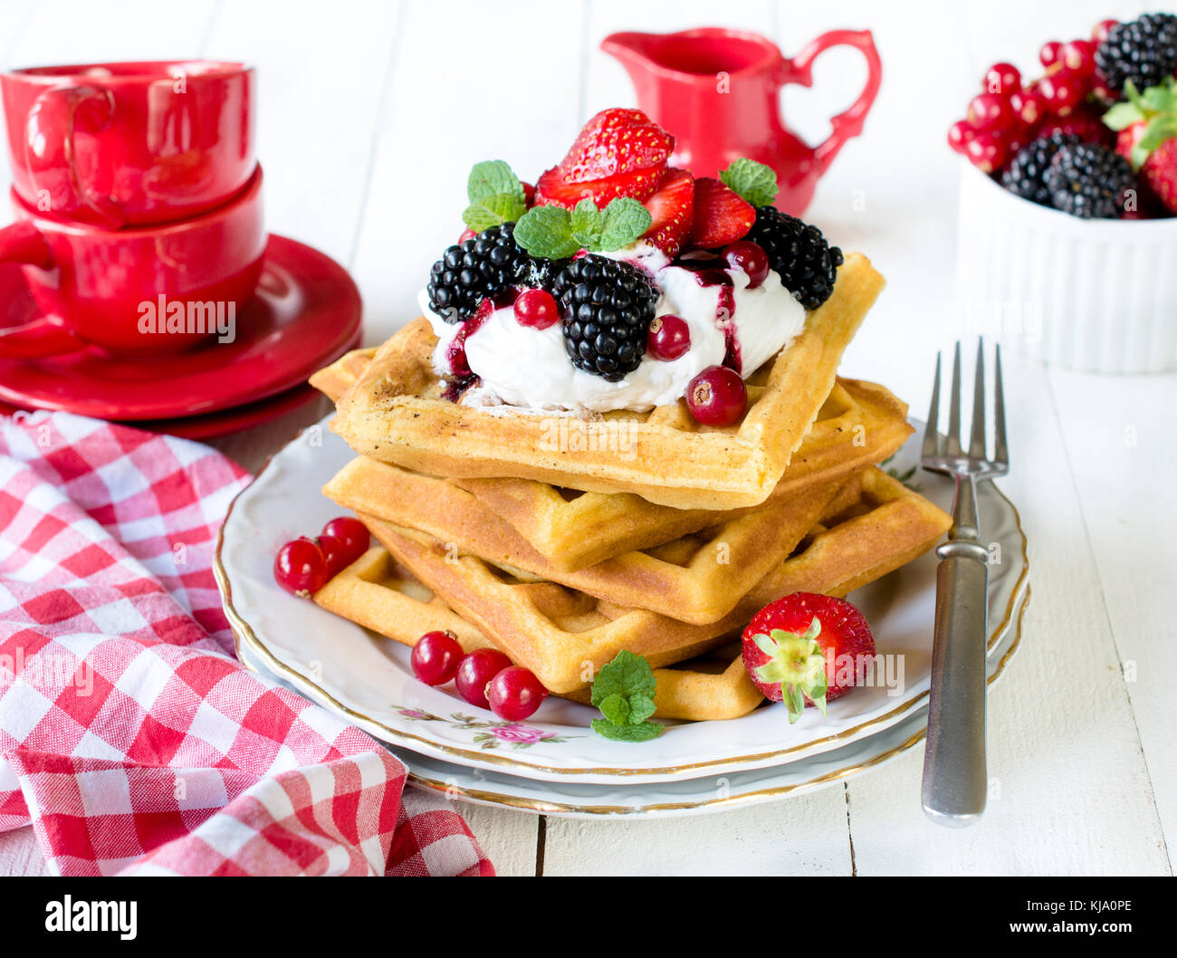 Traditional Belgium waffles with berry fruits and vanilla cream ...
