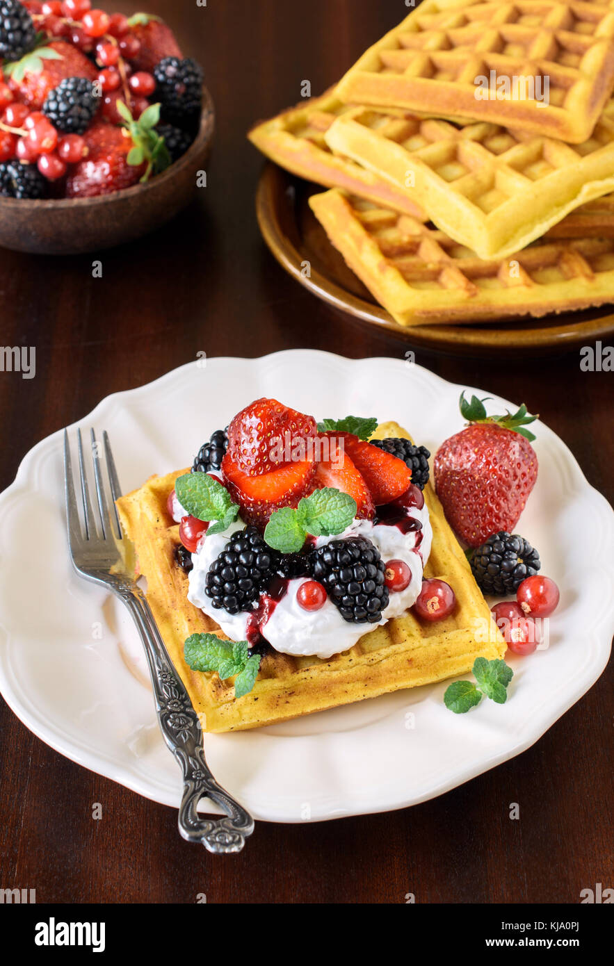 Traditional Belgium waffles with vanilla cream and berry fruits ...