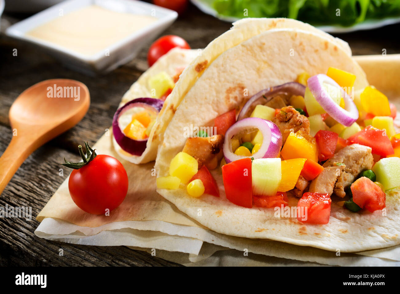 Traditional Mexican tortilla bread stuffed with meat and vegetables on the table.Selective focus