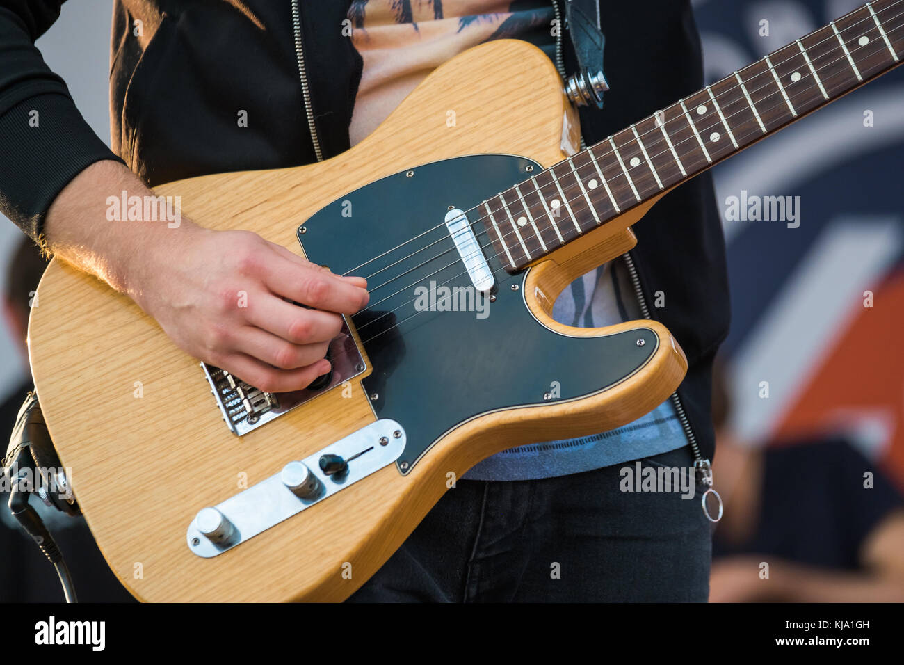 Pan playing electric guitar at concert Stock Photo Alamy