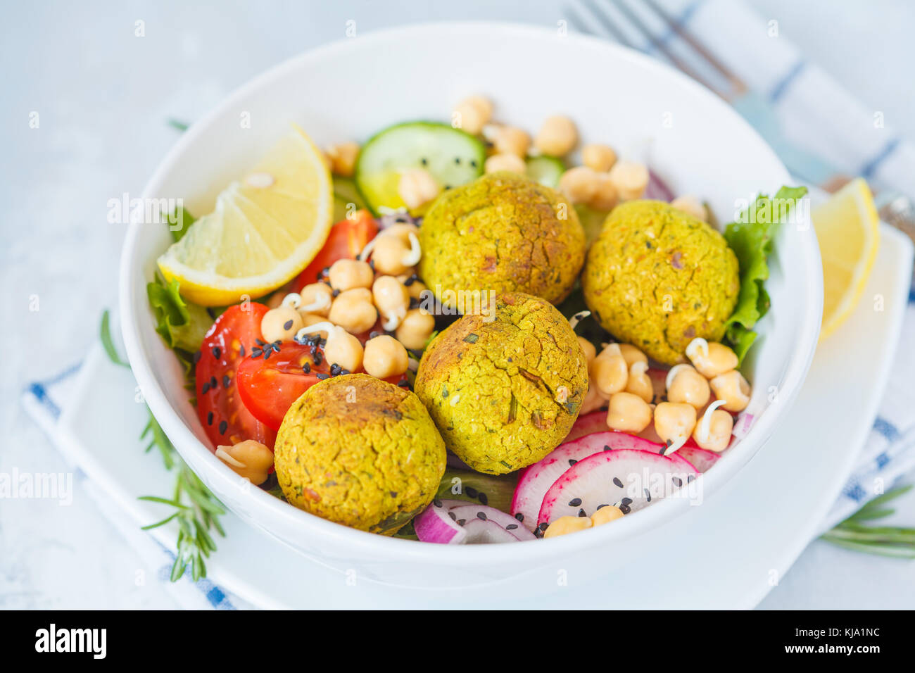 Baked falafel salad with vegetables and sprouted chickpeas. Vegan Healthy Food Concept. Stock Photo