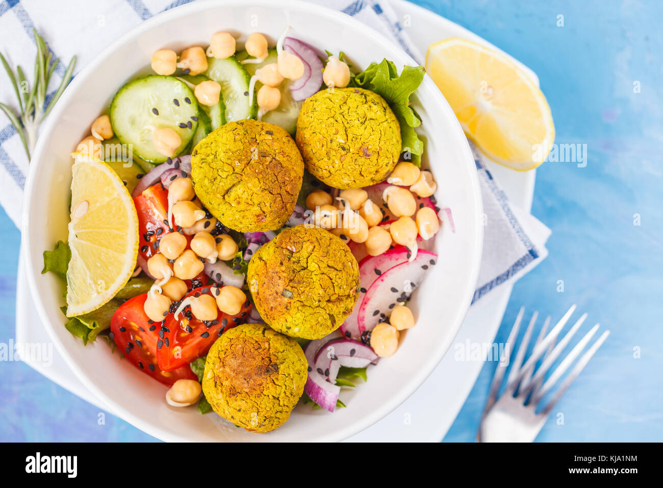 Baked falafel salad with vegetables and sprouted chickpeas, blue