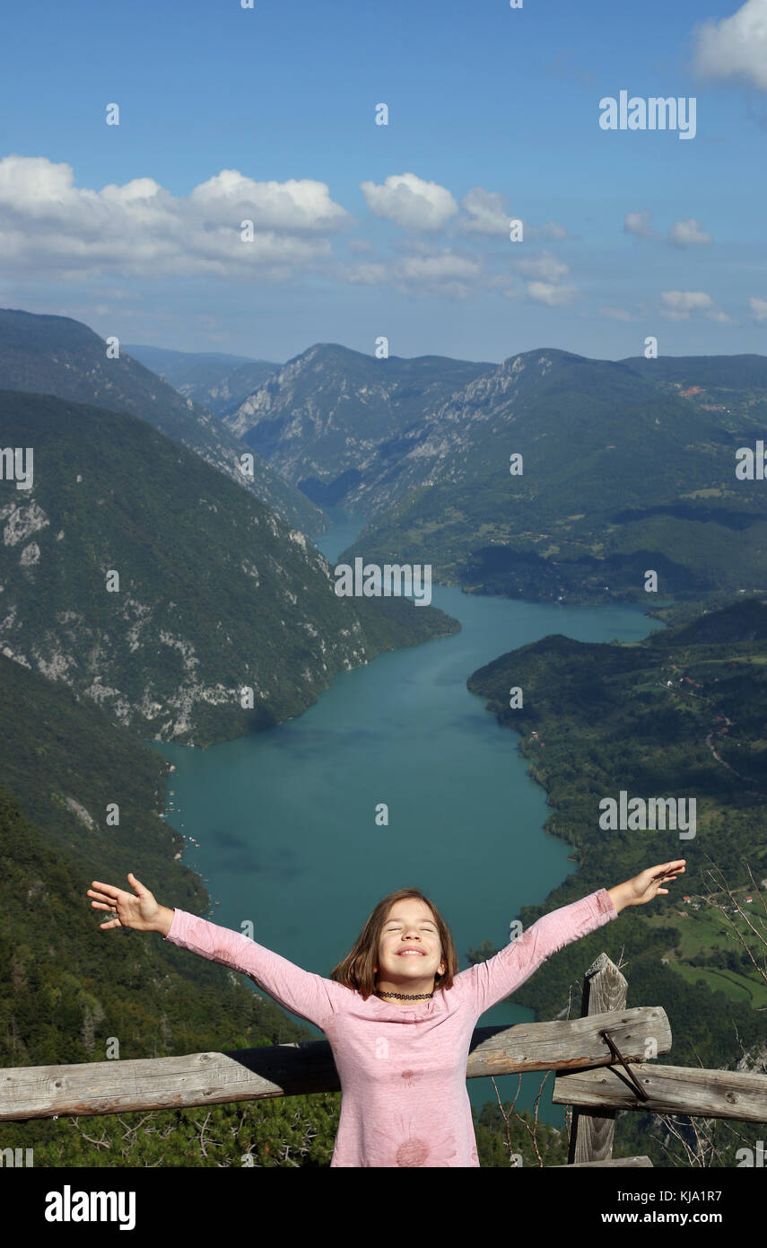 happy little girl with hands up on mountain enjoy in nature Stock Photo ...