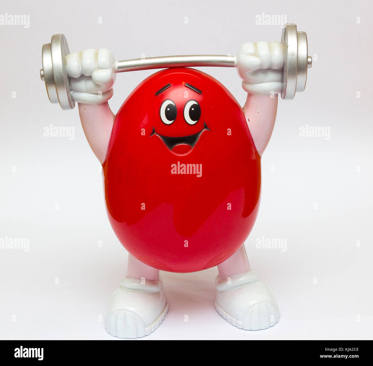 A Plastic moulded novelty M&M  community sweet container in a red weight lifter cartoon style without the trade mark and logo Stock Photo