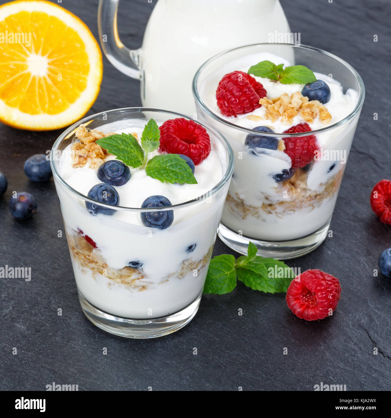 Berry yogurt yoghurt with berries fruits cup muesli square slate breakfast food Stock Photo