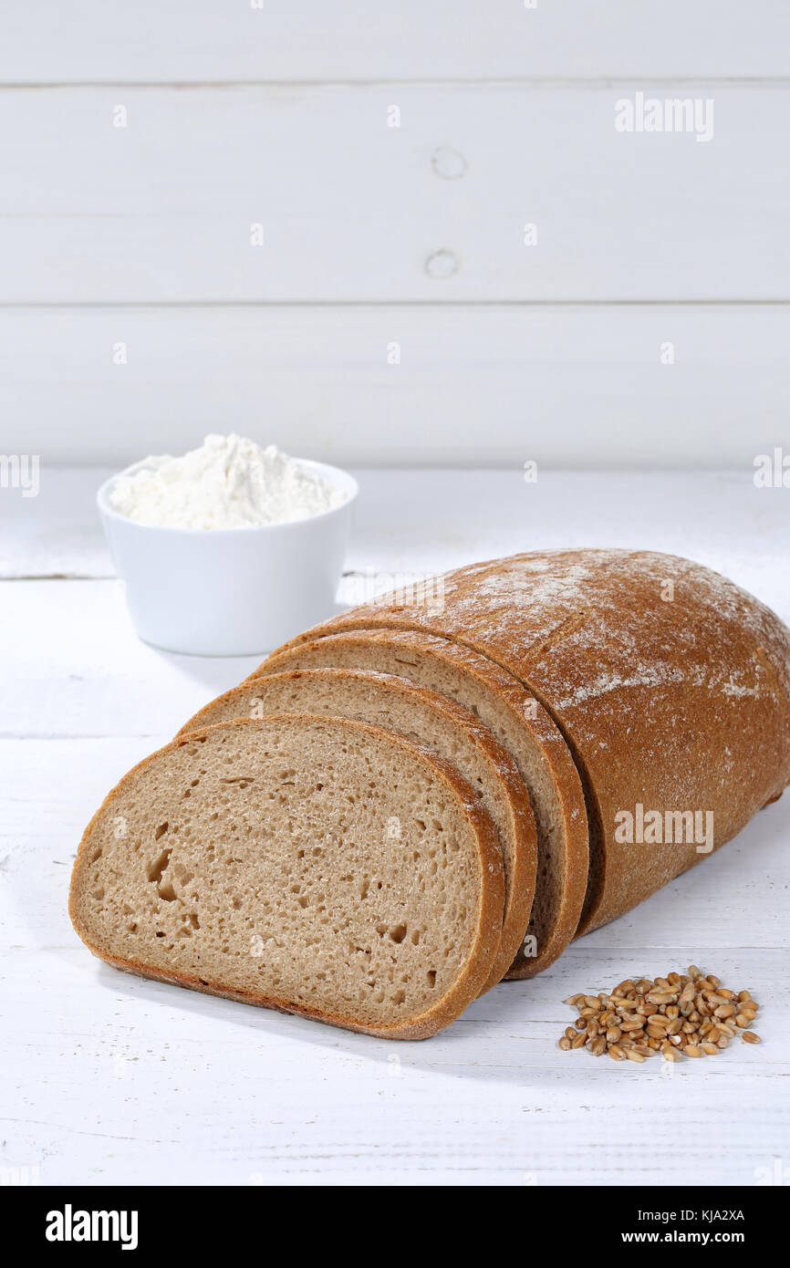 Wheat bread slice slices sliced loaf portrait format copyspace on wooden board wood Stock Photo